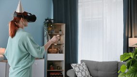 online holiday, a young woman in a festive cap congratulates her friend on his birthday using Viar glasses and virtual communication while standing in living room - Powered by Shutterstock - Get 15% off with code: PIKWIZARD15