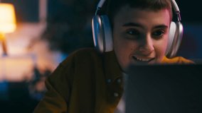 Excited teen boy in headphones playing racing game on laptop, relaxation, hobby