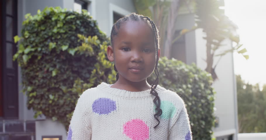Portrait of happy african american girl with braided hair smiling in sunny garden, slow motion. Childhood, free time, wellbeing and lifestyle, unaltered. | Shutterstock HD Video #1109276469