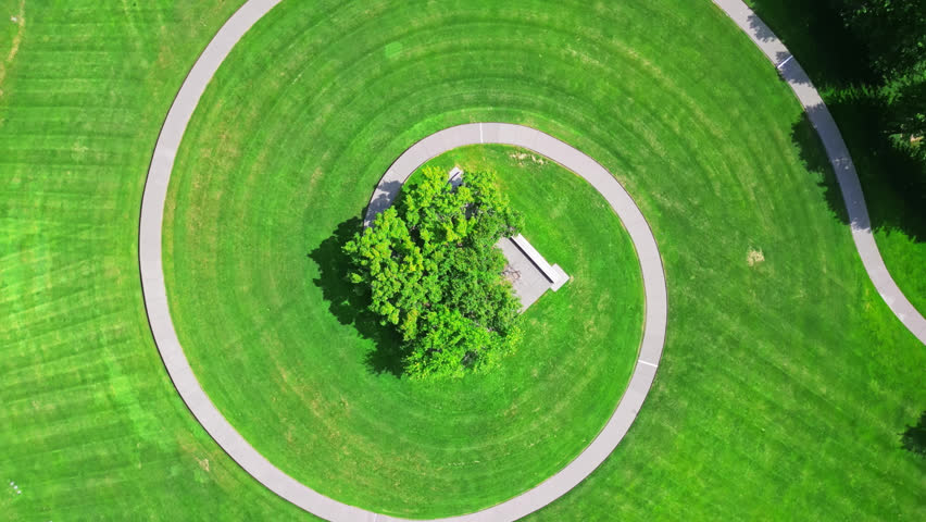 Sunny Day On A Mound With A Spiral Footpath In Gold Medal Park In Minneapolis, Minnesota, USA. Aerial Stepdown