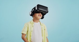 Glasses, virtual reality and child in metaverse, 3d games or futuristic technology for school or futuristic e learning in studio. Kid with high tech, VR education and watch video on a blue background