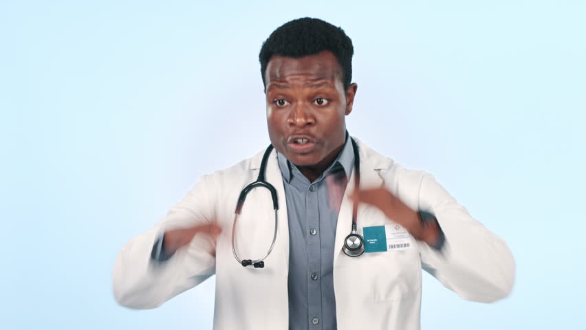 Man, angry doctor and screaming for stress in studio isolated on a blue background. Frustrated African medical professional shouting, talking and complaining for healthcare mistake, fail and annoyed Royalty-Free Stock Footage #1109280033