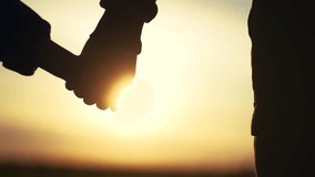 father holding daughter hands. close-up hands parent holding child girls daughters sunset silhouette. friendly family kid dream concept. fathers lifestyle day concept - Powered by Shutterstock - Get 15% off with code: PIKWIZARD15