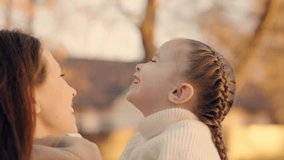 Little daughter, baby hugging mom on street. Child mother outdoor. Mom child hugging in park in autumn. Happy children family. Young carefree mother, smiling daughter have fun communicating in nature - Powered by Shutterstock - Get 15% off with code: PIKWIZARD15