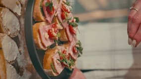 Vertical video, close-up of bruschettas that are paired with nuts. An appetizer for the table. Home kitchen and cooking. 