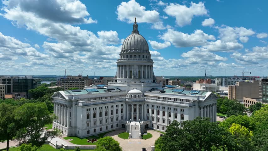 Wisconsin capitol building. Aerial establishing shot of stoic government building in Madison, WI on beautiful summer day.