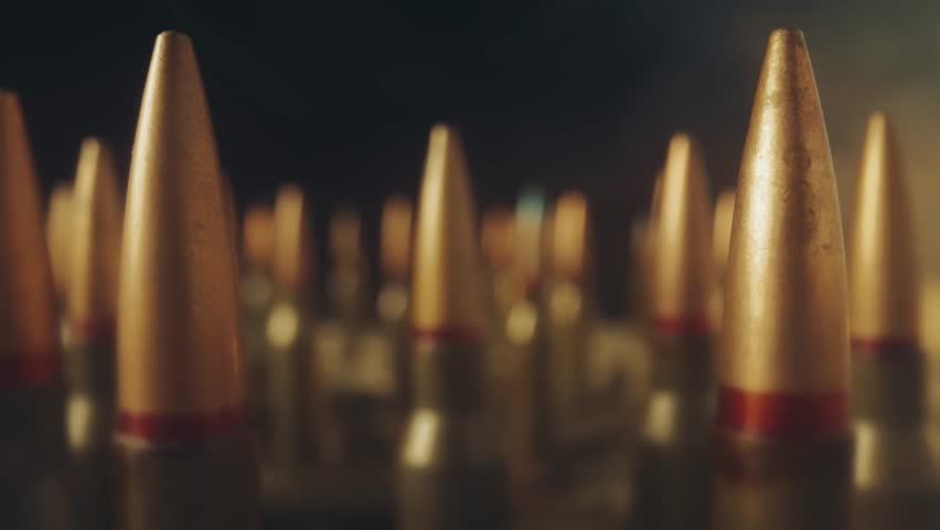 Rifle bullets on a black background in puffs of smoke close up. Rows of bullets. Concept on the theme of war, resistance and crisis.