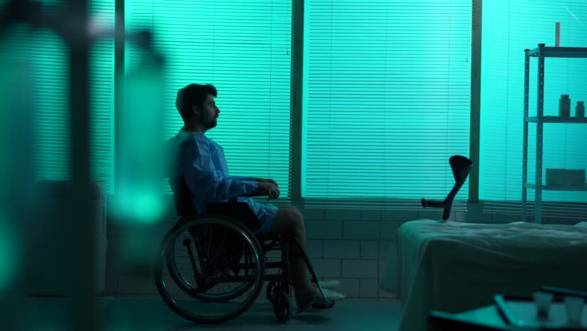 Full-sized silhouette video of a disabled man, patient with mobility impairment trying to get up from a wheelchair, making a few succesful steps leaning on a crutch.