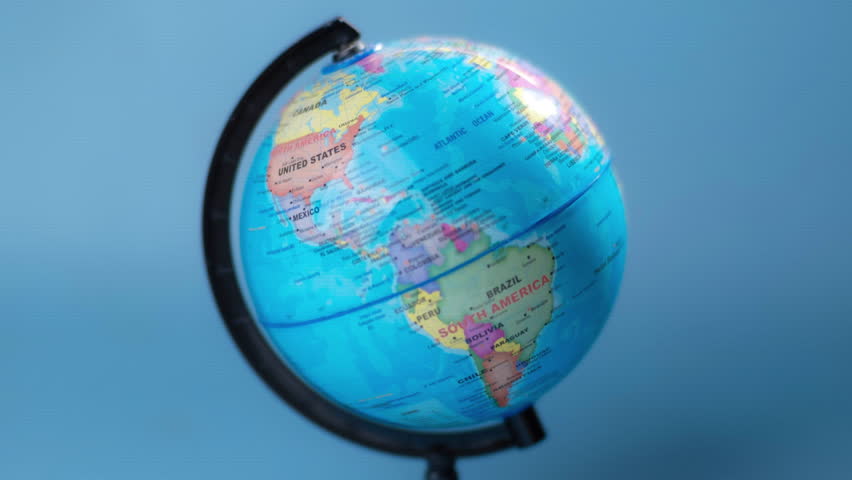 Stop motion of spinning globe isolated on blue background.
