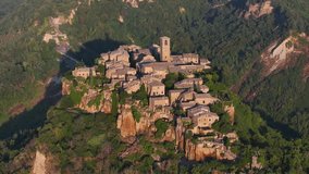Establishing Aerial View Shot of Civita di Bagnoregio village, located on top of a volcanic tuff hill overlooking the Tiber river valley, province of Viterbo, Lazio, Italy