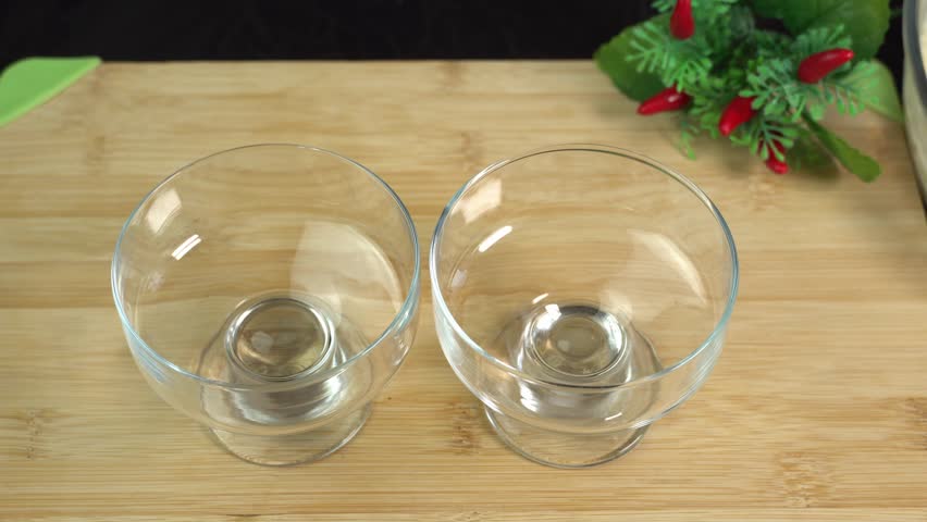 Homemade ice cream prepared at home, hand placing scoops of ice cream in dessert bowl