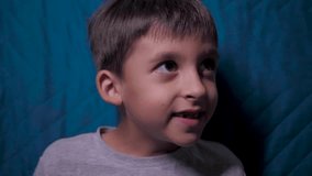 child a boy of six years old is sitting on the couch at home in the evening and playing video games with a black joystick - Powered by Shutterstock - Get 15% off with code: PIKWIZARD15