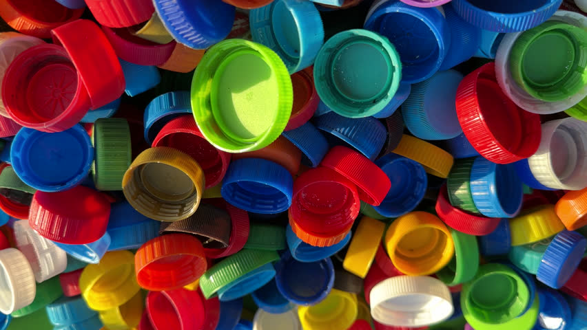 Recycling Plastic Bottle Caps. Plastic Material is Recyclable. Remove Lids from Plastic Bottles before Recycling. Plastic Waste Collection for Recycling. Drink Bottle caps to conversion and Reuse. | Shutterstock HD Video #1109293861