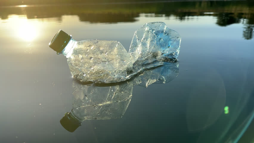 Marine plastic pollution from human activities at coastlines. Plastic waste in lake. Microplastics in groundwater. Ocean pollution and marine debris. Litter such as plastic from food in water of river | Shutterstock HD Video #1109293865