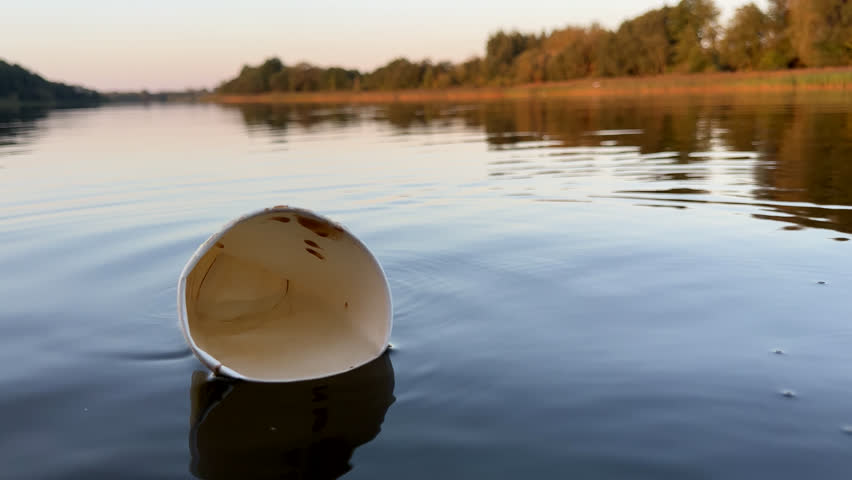 Water pollution. Coffee paper cup Garbage. Marine pollution. Aquatic trash. Paper coffee cup Waste in lake. Wastewater management. Litter in water, garbage, waste in ocean. Paper cup litter in lake  | Shutterstock HD Video #1109293919