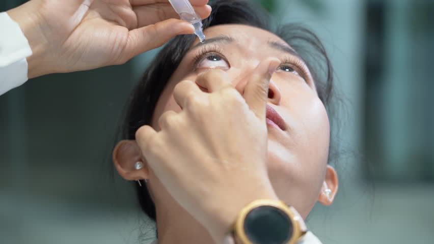 
asian business woman feels eye fatigue or dry eye uses eye drops while long working with laptop computer office.  Royalty-Free Stock Footage #1109301765