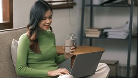 Happy asian woman speak conference on laptop in video call people smart working from home.