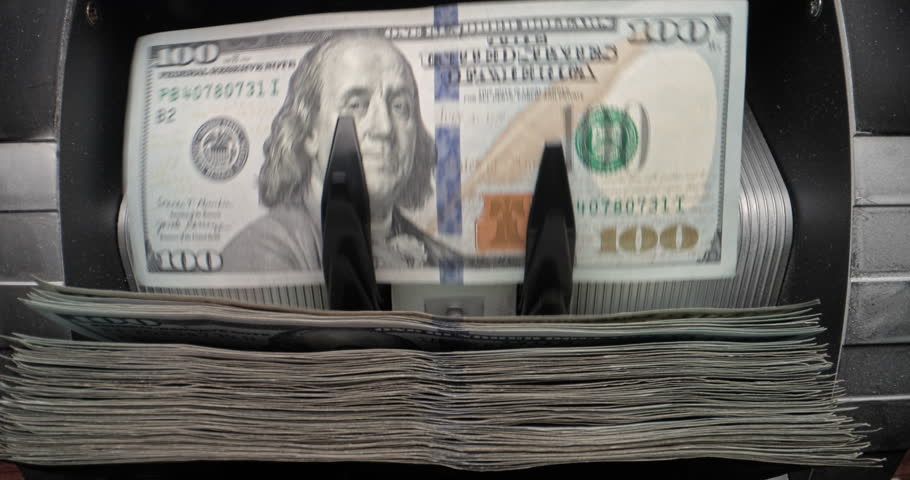 Money cash counting equipment. Macro shot cash counting machine calculating 100 dollar bills. Automatic financial operations, official currency of United States of America. Dollar buck, money cash.