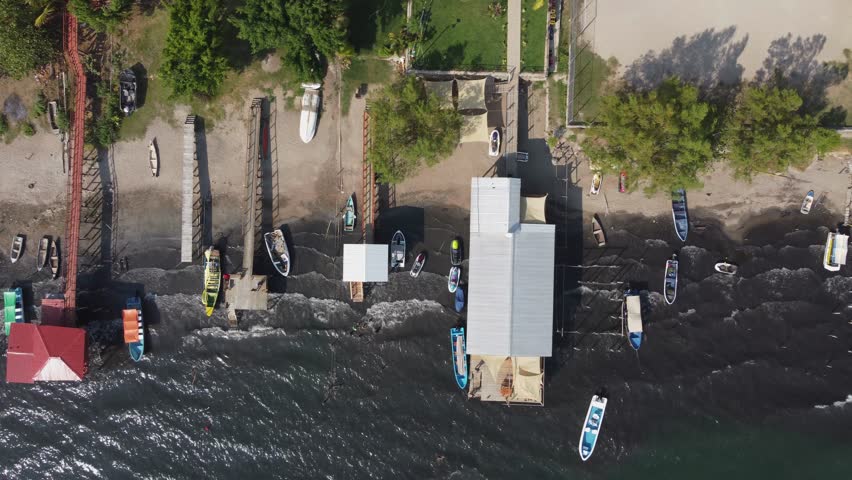 Aerial view: Waves splash on shore: Lago Coatepeque lake, El Salvador | Shutterstock HD Video #1109313723
