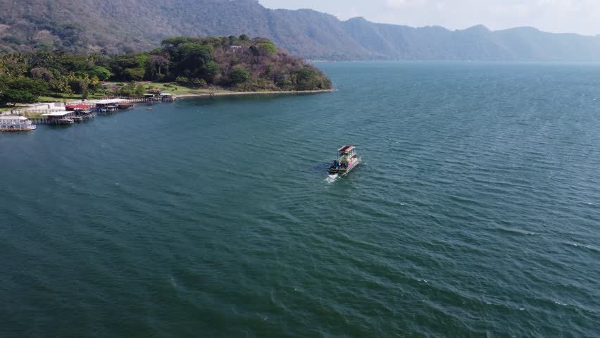 Tour boat takes tourists onto large volcanic caldera lake, El Salvador | Shutterstock HD Video #1109313807