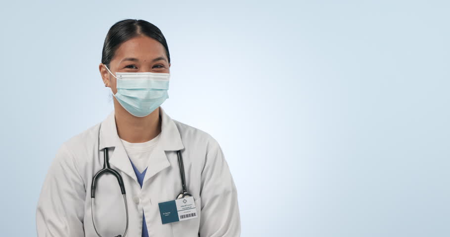 Clinic woman, face mask and doctor point at hospital promo, brand or pharmacy notification, advertising or discount service. Studio portrait, health mockup space or nurse news deal on blue background