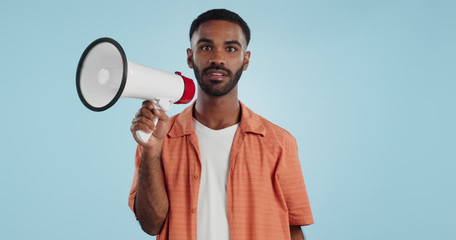 Young man, megaphone and announcement, choice or broadcast for winner, join us or winning opportunity in studio. Face of african person with voice, pointing you and competition on a blue background Royalty-Free Stock Footage #1109314471