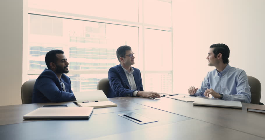 Three multiethnic businesspeople holds negotiation in modern boardroom, conclude partnership agreement handshake, starting joint project, make commercial deal in office, sell and buy company services Royalty-Free Stock Footage #1109316741