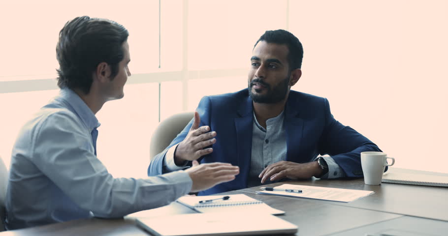 Two successful businessmen discuss terms of contract make business commercial deal, finish meeting shake hands. Satisfied partners sit at desk in office, handshake, accomplish negotiation. Partnership | Shutterstock HD Video #1109316757