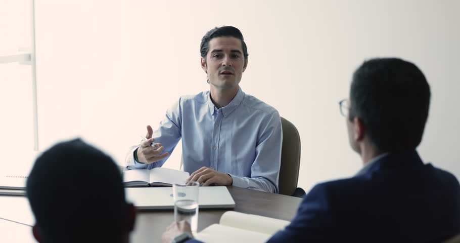Hispanic businessman makes speech, share opinion, ideas and strategy during briefing with colleagues. Company boss negotiating with clients, convincing, makes commercial offers take part in meeting | Shutterstock HD Video #1109316765