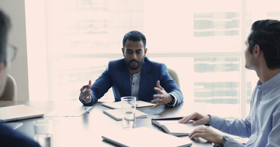 Indian businessman in suit, team leader, boss lead formal meeting with partners in office, make speech, share opinion and solution, provide information, convincing to company client to buy services | Shutterstock HD Video #1109316767