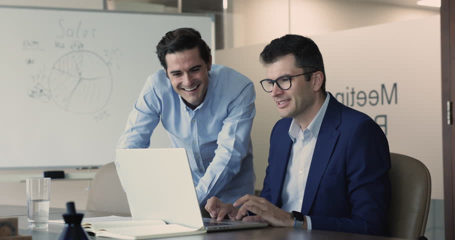 Multiethnic teammates using laptop met in office meeting room, mentor help with program to workmate, learn new software, share ideas, working on strategy, prepare on-line presentation. Apprenticeship | Shutterstock HD Video #1109318357