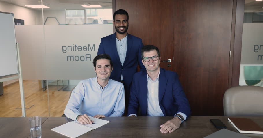 Group of three multiethnic businessmen gathered in modern meeting room smile look at camera. Successful young and middle-aged professional teammates, employees portrait. Career, business, leadership | Shutterstock HD Video #1109318369