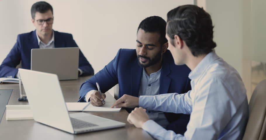 Male mentor teaching Indian intern, training new employee in office, apprentice make notes, gain new knowledge at meeting with coach, jotting information, receive skills. Mentorship, apprenticeship | Shutterstock HD Video #1109318381