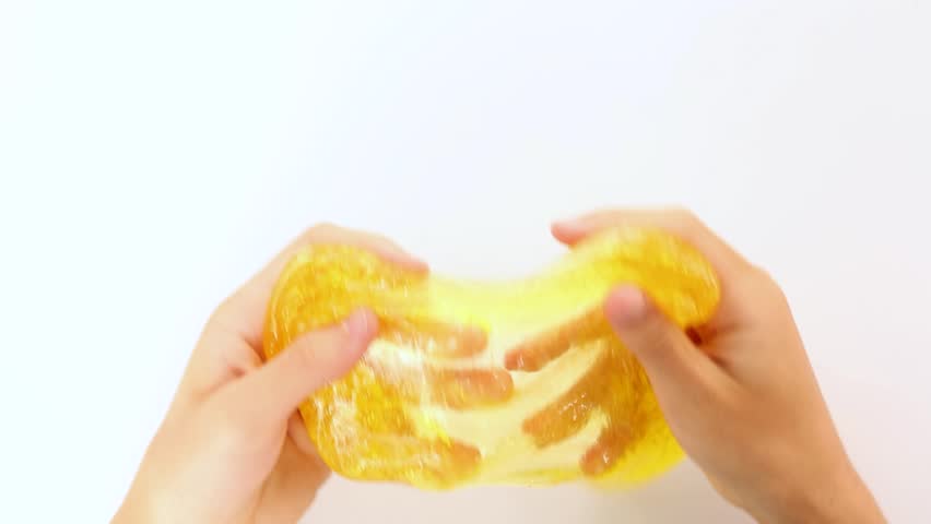 Asmr. Hands slowly, calmly stretch the transparent, yellow mucus. Auditory and visual effect of relaxation, pacification, getting high, enjoying, stress relief. Conceptual.relieves stress | Shutterstock HD Video #1109322327