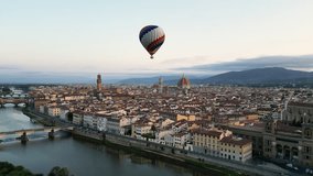 Florence, Colorful hot air balloon epic flying above the city at sunrise, Cathedral of Saint Mary of the Flower, Palazzo Vecchio, Tuscany, Italy - Powered by Shutterstock - Get 15% off with code: PIKWIZARD15