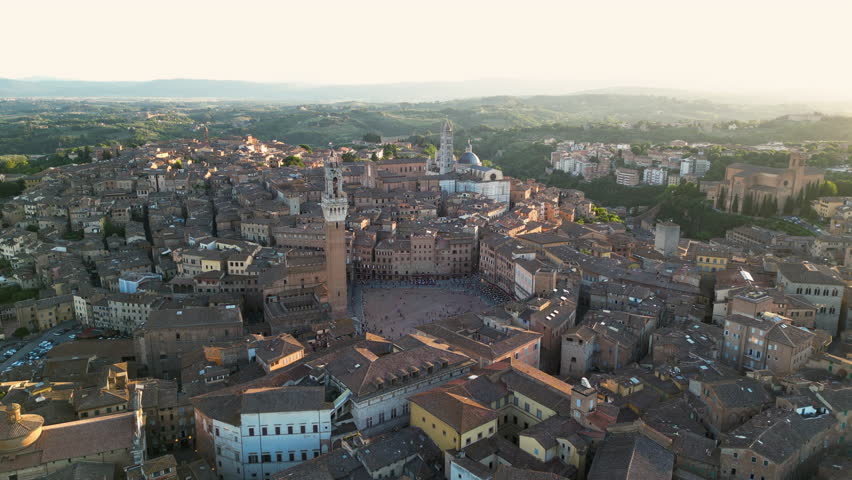 Siena, Tuscany, aerial view of the medieval town at sunset, Piazza del Campo, Palazzo Pubblico, and Torre del Mangia, Duomo di Siena, Italy Royalty-Free Stock Footage #1109323721