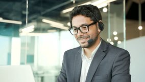 Close up. Corporate operator who works in customer support speaks on a video call using a laptop. Call center agent in wireless headset helping customer with complaints in office. Online consultation - Powered by Shutterstock - Get 15% off with code: PIKWIZARD15