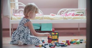 Cute little girl playing with toy blocks. Shoot on Digital Cinema Camera in 4K - ProRes 422 codec.