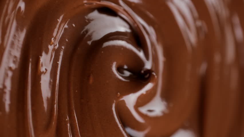 Melted premium chocolate, rotating. Confectionery concept. Vertical video