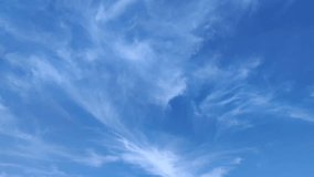 Cirrus clouds move across the sky in the afternoon