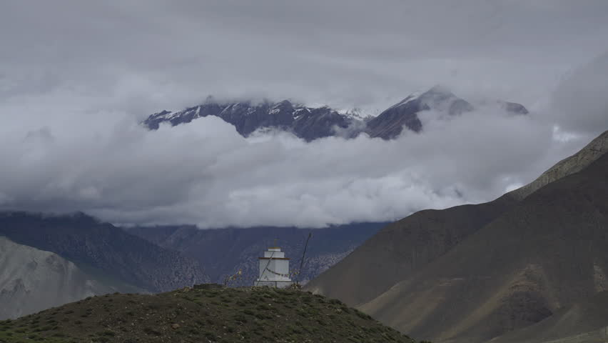 Time lapse of clouds in the mountain. Trek around Annapurna, Buddhist stupa on the hill. Nepal, Himalayas. 4K