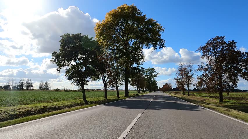 Beautiful nature of Poland autumn. The car is driving on the road Poland.