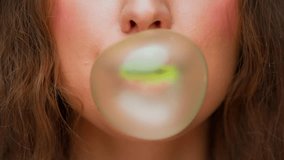 Portrait of Young Woman Chewing Gum and Blowing Colorful Bubble on Camera. Crop Face of Cute Female Human Showing Trick with Bubblegum Ball. Real Person Fun Playing with Green Fruity Balloon in Mouth - Powered by Shutterstock - Get 15% off with code: PIKWIZARD15