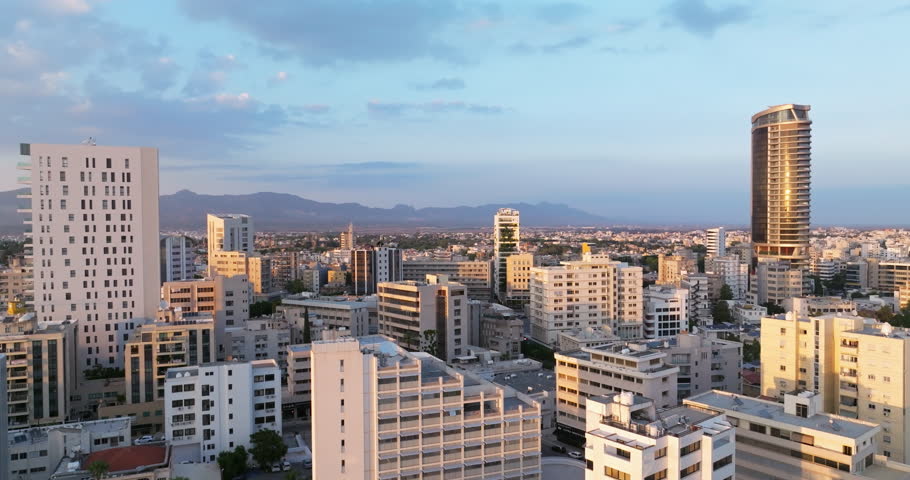 Aerial view of the urban landscape of the business district at sunset in the city. High quality 4k footage
