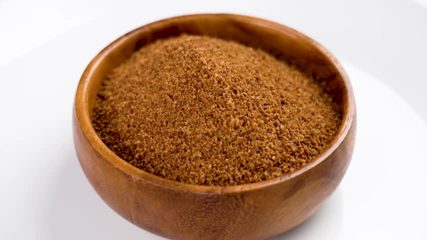 Full teaspoon of coconut sugar. Measuring unrefined sweet coco ingredient for making tea. Rotation Royalty-Free Stock Footage #1109358323