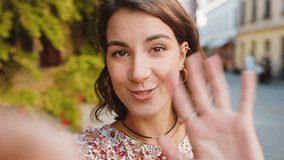 POV view of young woman blogger taking selfie on smartphone, communicating video call online with subscribers, recording stories for social media vlog outdoors. Adult girl walking in urban city street - Powered by Shutterstock - Get 15% off with code: PIKWIZARD15