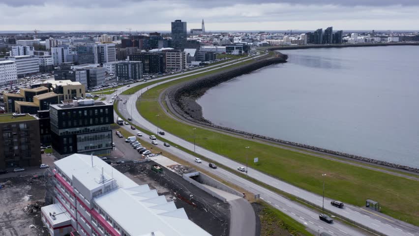 Shoreline of Reykjavik skyline in Iceland, shore walk path and Hofdi lighthouse