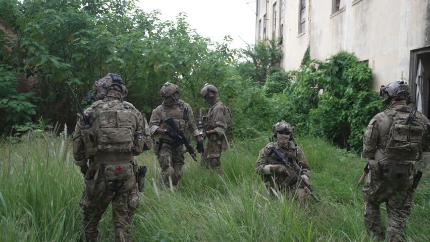 Soldier in civil war, ruined building. Close quarter battle and civil war concept.