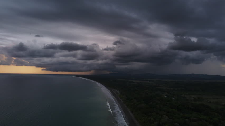 Aerial shot above the dark sky in Costa Rica and the Pacific Ocean, a big storm is coming.