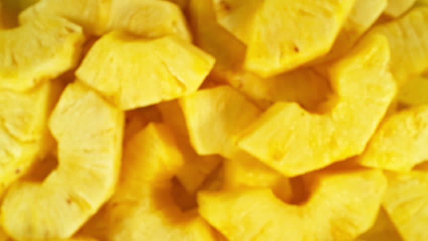 Super Slow Motion Shot of Flying Fresh Pineapple Slices at 1000 fps.